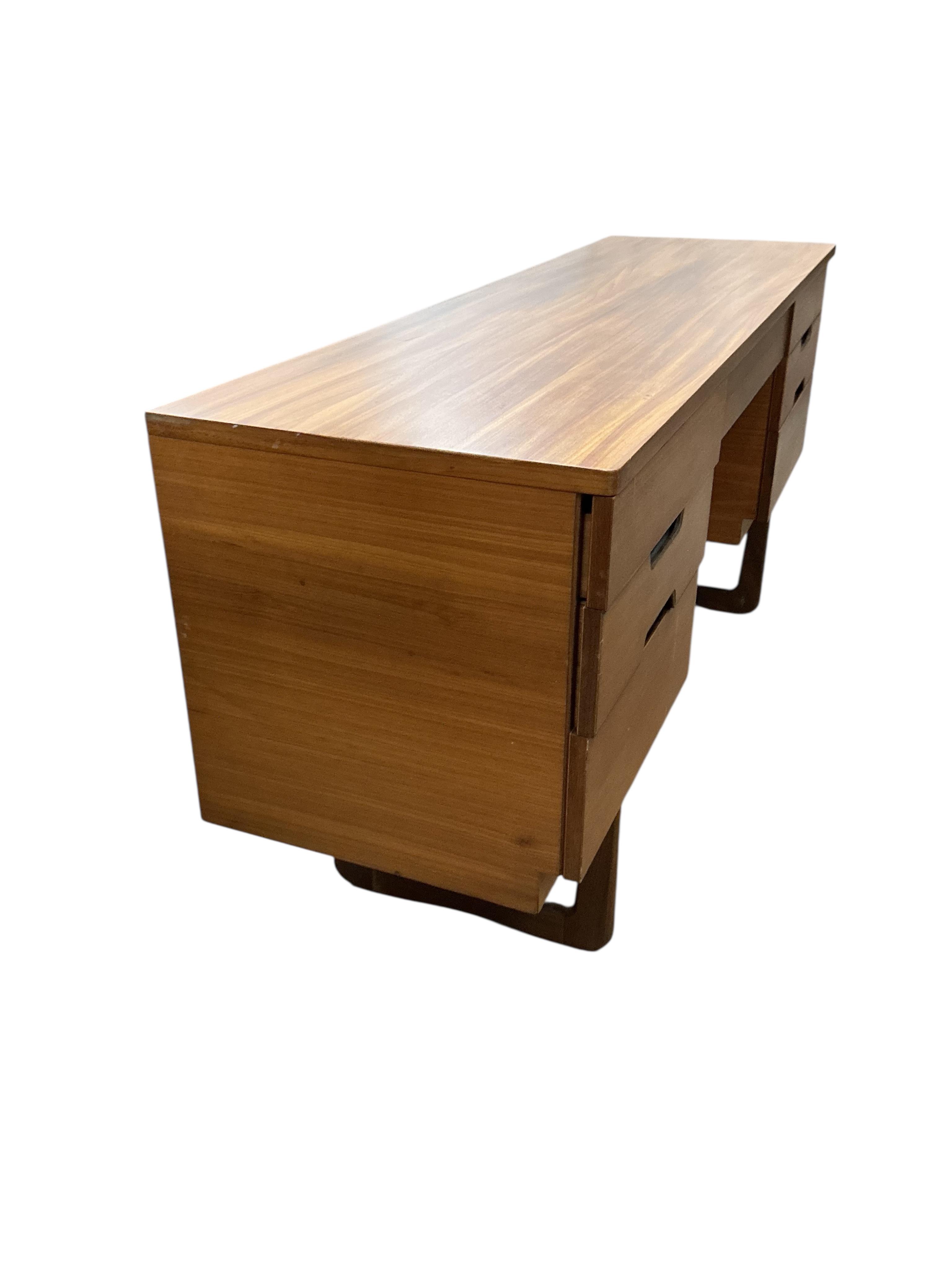 A mid century Uniflex teak kneehole dressing table, width 152cm, depth 46cm, height 71cm